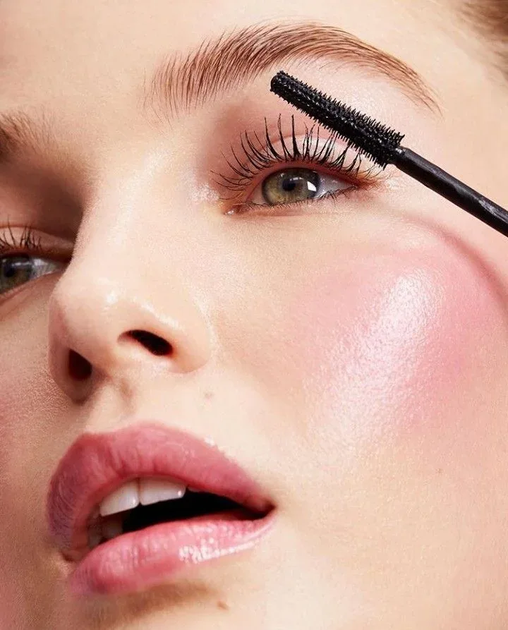 Close-up of a mascara brush and defined lashes