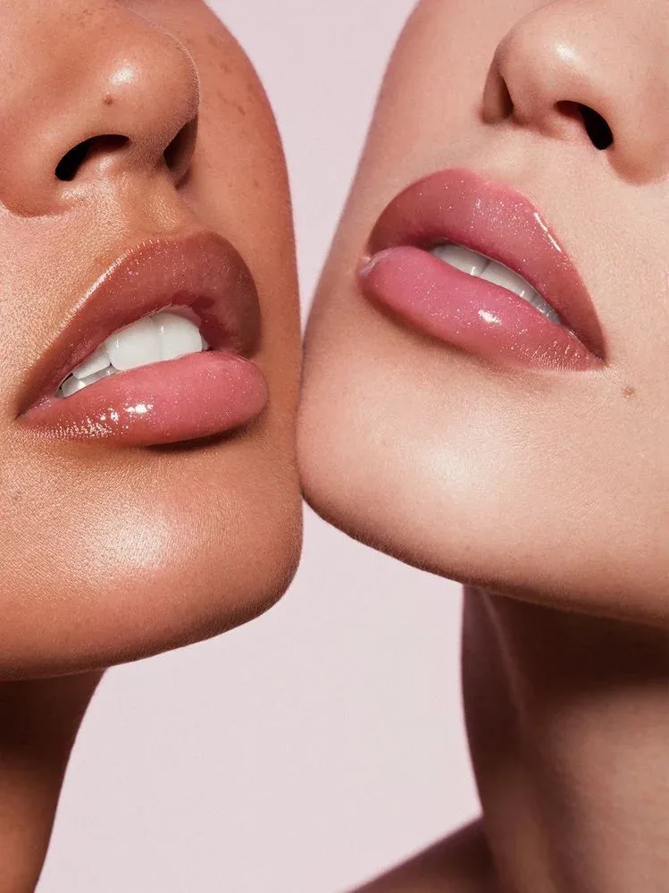 Glossy lip finishes on two skin tones