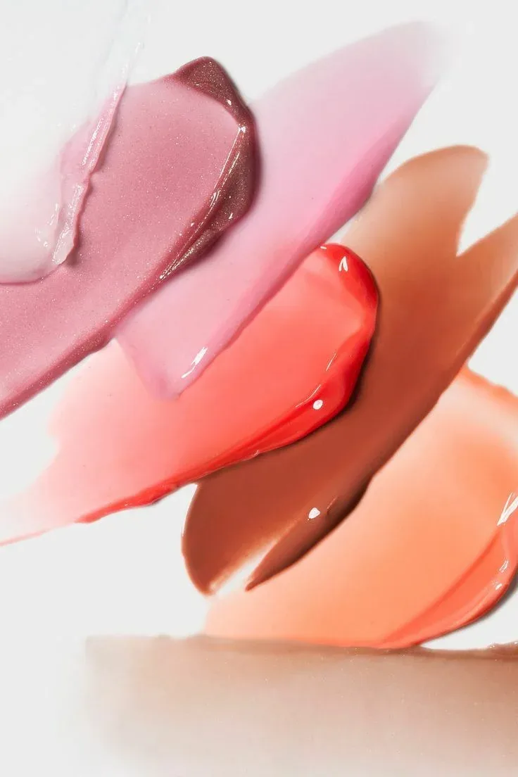 Translucent pink, coral and nude cosmetic swatches showing different finishes