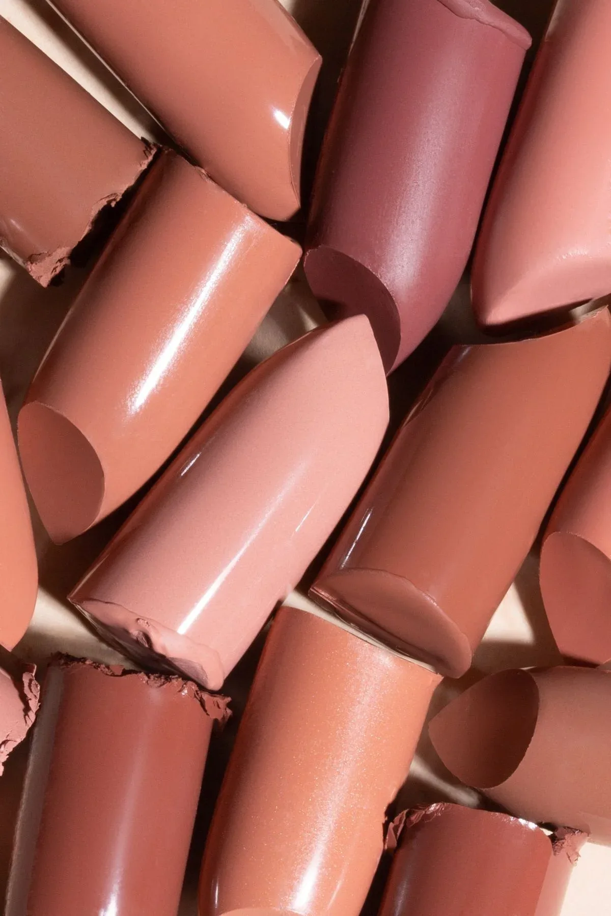 A macro study of lipstick textures in warm nude and rose shades