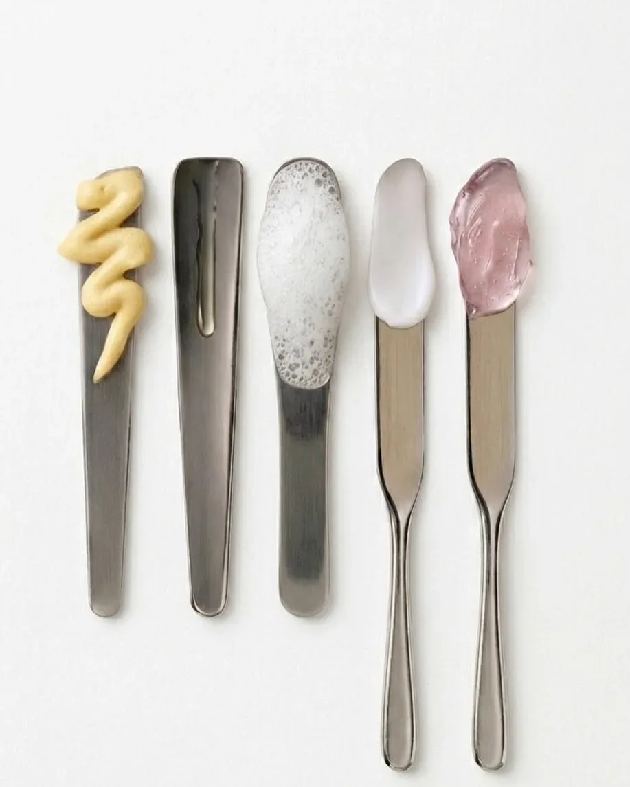 Five metal spatulas showing cream, gel and foam textures